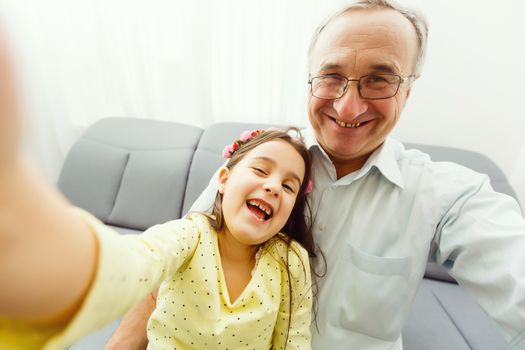 Grandfather and granddaughter make selfie