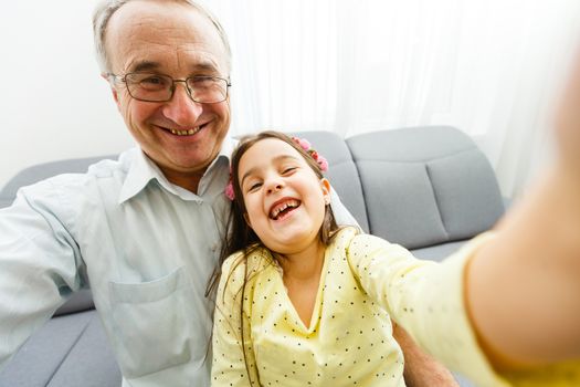 Grandfather and granddaughter make selfie