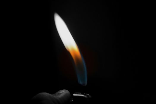 Cigarette lighter burning realistic flame on a black background