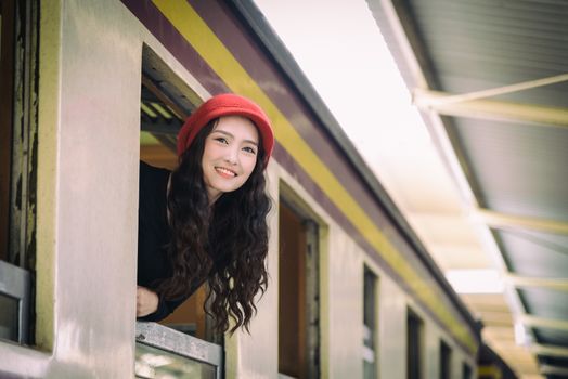 Asian woman traveler has exciting with traveling by train at Hua Lamphong station at Bangkok, Thailand.