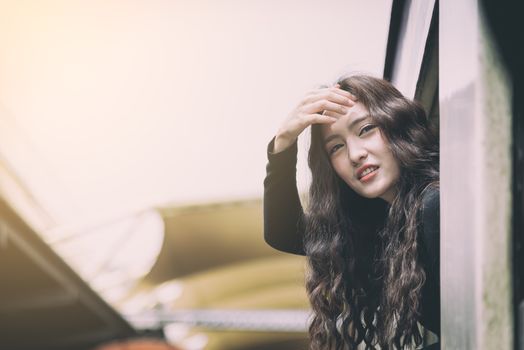 Asian woman traveler has exciting with traveling by train at Hua Lamphong station at Bangkok, Thailand.