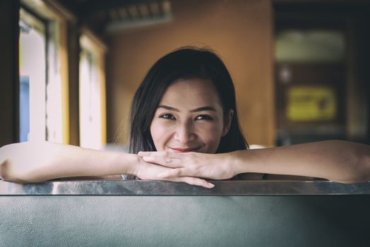 Asian woman traveler has exciting with traveling by train at Hua Lamphong station at Bangkok, Thailand.