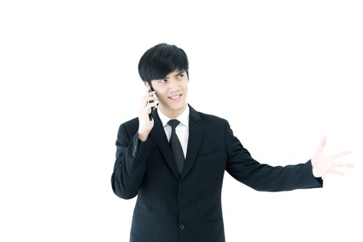 Asia businessman with black suit and black necktie has talking by  phone with upset isolated on white background.