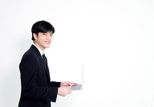 Asian business handsome man has holding laptop for woking with happy and relaxing isolated on white background.