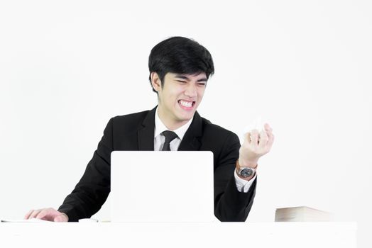 Asian manager businessman sitting at desk has destroy paper with feeling angry and upset by hand, isolated on white background.