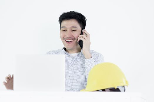 Asian employee engineer salary man sitting at desk and talking with phone, isolated on white background.