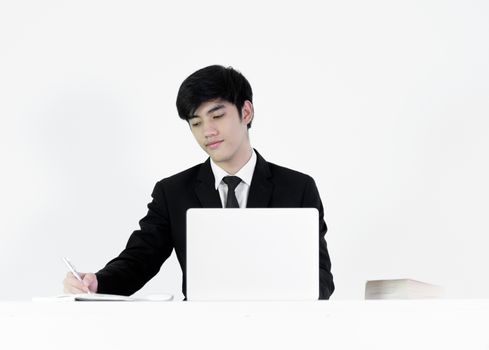 Asian manager businessman sitting at desk and working, isolated on white background.