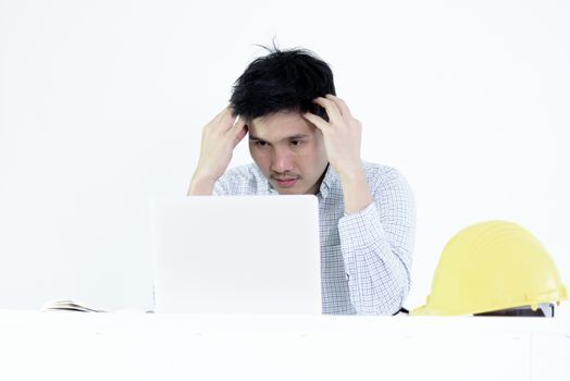 Asian employee engineer salary man sitting at desk and working with feeling worry and boring, isolated on white background.