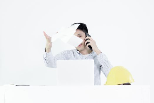 Asian employee engineer salary man sitting at desk throwing papers with feeling angry and upset, isolated on white background.