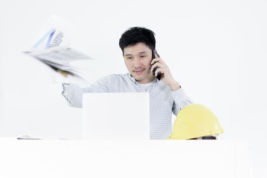 Asian employee engineer salary man sitting at desk throwing book with feeling angry and upset, isolated on white background.