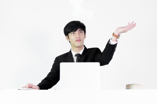 Asian manager businessman sitting at desk throwing papers with feeling angry and upset, isolated on white background.