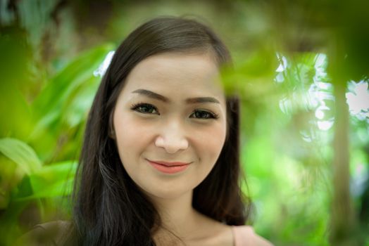 Asian pretty girl has relaxing with happy and smiling at Little Tree Garden cafe, Nakhon Pathom province, Thailand in the morning.