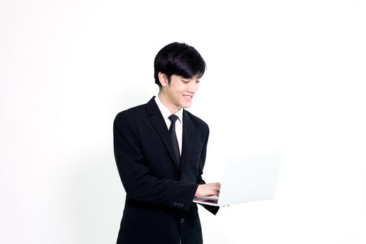 Asian business handsome man has holding laptop for woking with happy and relaxing isolated on white background.