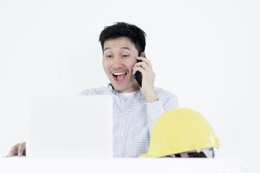 Asian employee engineer salary man sitting at desk and talking with phone, isolated on white background.