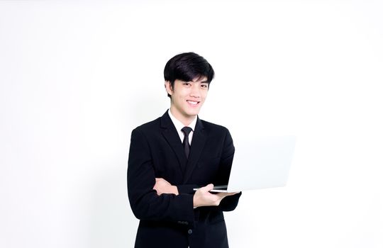 Asian business handsome man has holding laptop for woking with happy and relaxing isolated on white background.