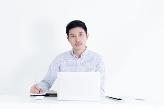 Asian employee salary man sitting at desk and working with lazy and sleepy, isolated on white background.