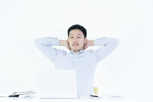 Asian employee salary man sitting at desk and working with lazy and sleepy, isolated on white background.