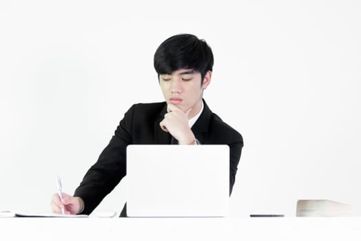 Asian manager businessman sitting at desk and working, isolated on white background.