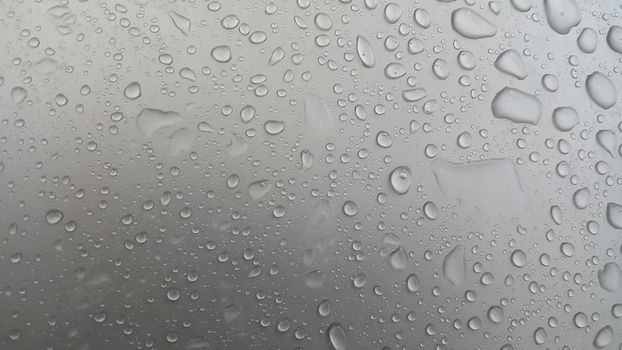 Water drops on grey silver color metallic sink