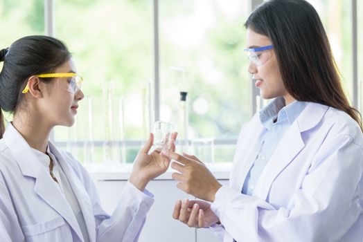 Asian young female working and research scientist together.