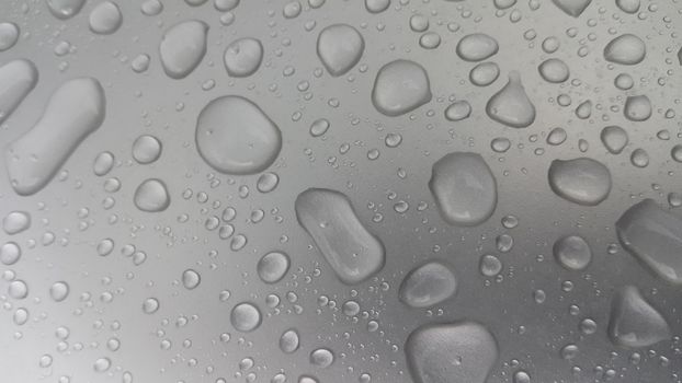 Water drops on grey silver color metallic sink