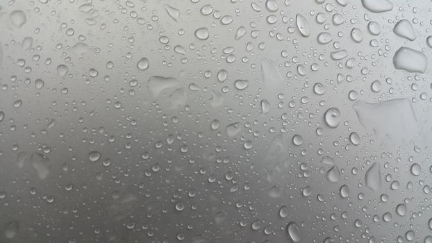 Water drops on grey silver color metallic sink