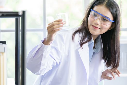 Asian young girl student scientist researching  and learning in a laboratory.