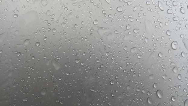 Water drops on grey silver color metallic sink