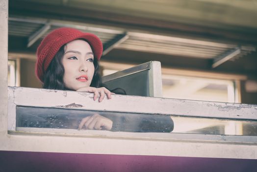 Asian woman traveler has exciting with traveling by train at Hua Lamphong station at Bangkok, Thailand.