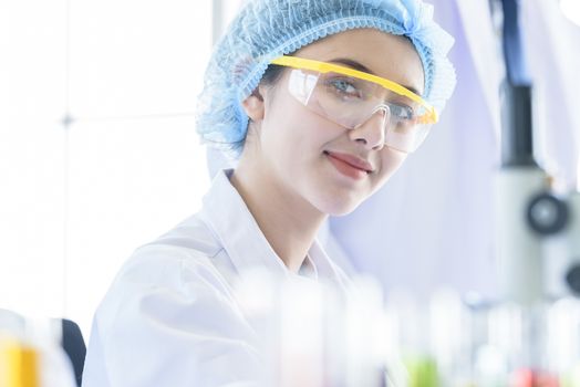 Asian young girl student scientist researching  and learning in a laboratory.