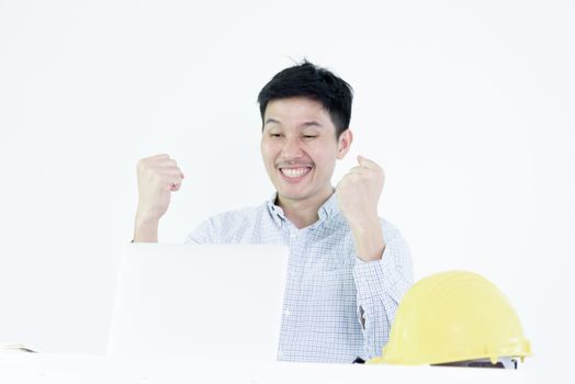 Asian employee engineer salary man sitting at desk and working with feeling successful and victory, isolated on white background.