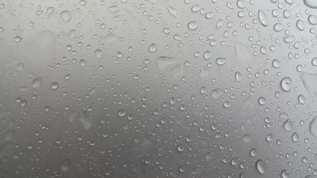 Water drops on grey silver color metallic sink