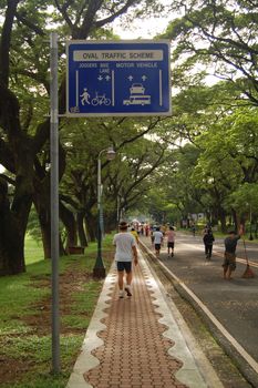 QUEZON CITY, PH - OCT. 8: Pathway and directional post at University of the Philippines on October 8, 2015 in Diliman, Quezon City, Philippines.