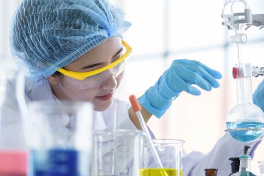 Asian young girl student scientist researching  and learning in a laboratory.