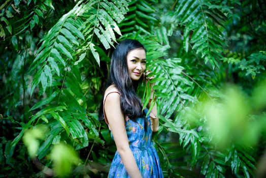 Asian pretty girl has relaxing with happy and smiling at Little Tree Garden cafe, Nakhon Pathom province, Thailand in the morning.