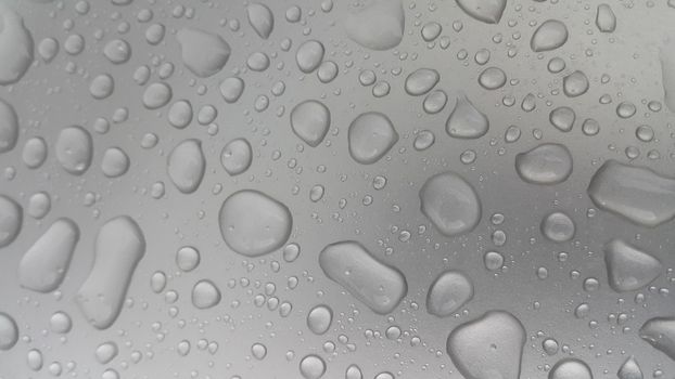 Water drops on grey silver color metallic sink