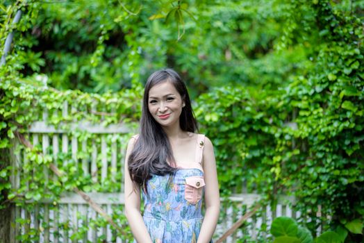 Asian pretty girl has relaxing with happy and smiling at Little Tree Garden cafe, Nakhon Pathom province, Thailand in the morning.