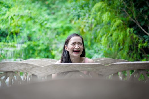 Asian pretty girl has sitting with happy and relaxing at Little Tree Garden cafe, Nakhon Pathom province, Thailand in the morning.