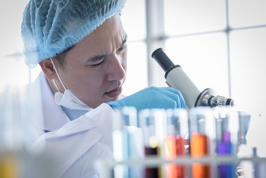 Asian man scientist researching  and learning in a laboratory.