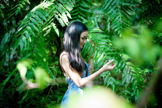 Asian pretty girl has relaxing with happy and smiling at Little Tree Garden cafe, Nakhon Pathom province, Thailand in the morning.