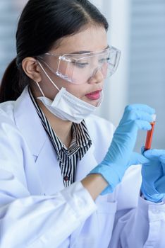 Asian young girl student scientist researching  and learning in a laboratory.