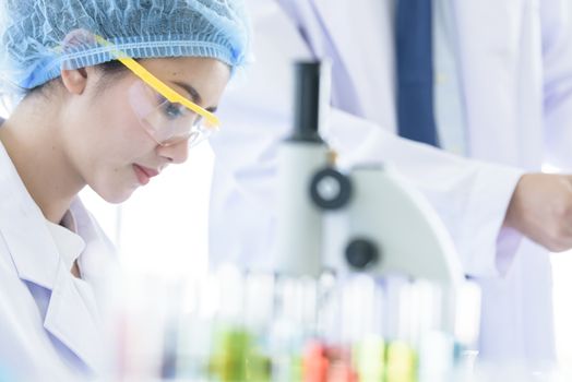 Asian young girl student scientist researching  and learning in a laboratory.