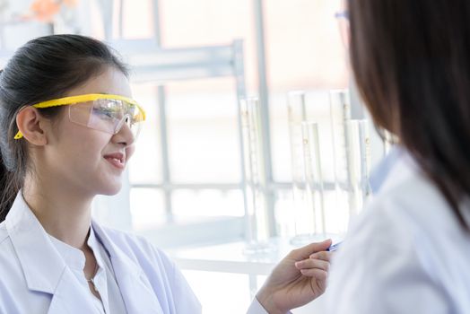 Asian young female working and research scientist together.