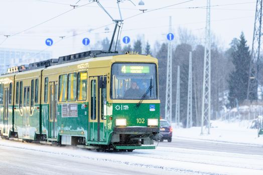 Editorial: Helsinki City, Finland, 21th December 2018. Train on the road with snow in winter season at Helsinki, Finland.