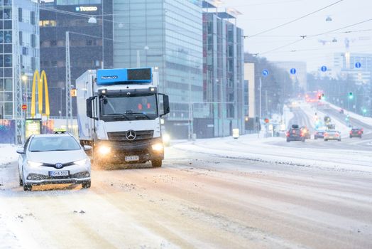 Editorial: Helsinki City, Finland, 21th December 2018. Car on the road with snow in winter season at Helsinki, Finland.