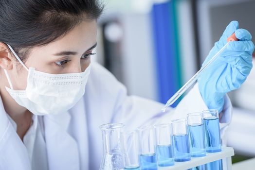 Asian young girl student scientist researching  and learning in a laboratory.