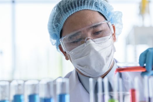 Asian man scientist researching  and learning in a laboratory.