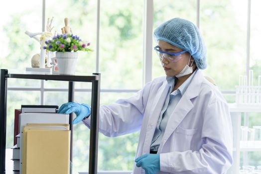 Asian young girl student scientist researching  and learning in a laboratory.