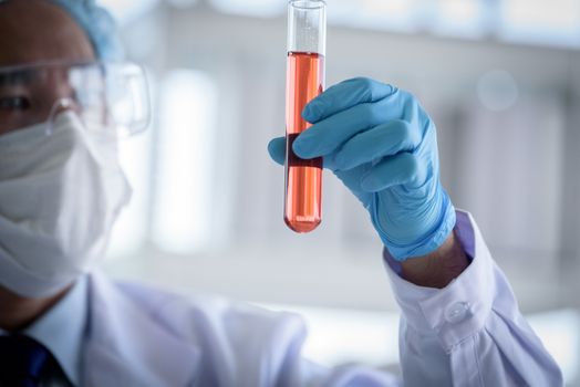 Asian man scientist researching  and learning in a laboratory.