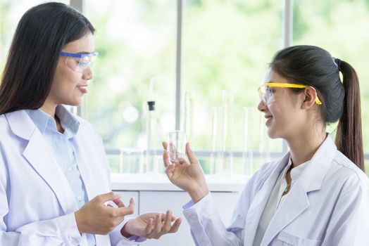 Asian young female working and research scientist together.